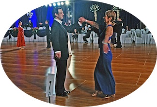 Mathew dancing with a student in competition